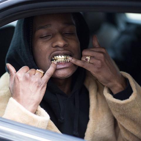 A$AP Rocky wearing gold top and bottom grillz